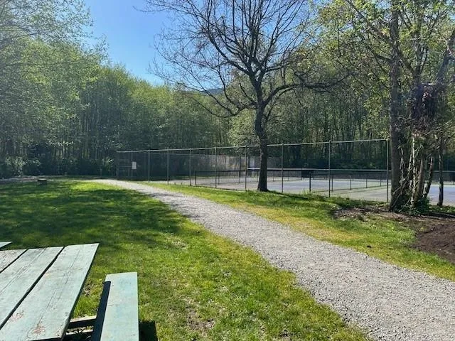 12 acres of community gardens, a playground , dog park and multi trails and walkways.