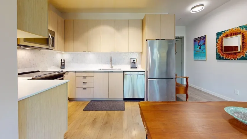 Kitchen featuring appliances with stainless steel finishes, ample counter and cupboard spaces in a well laid out design.