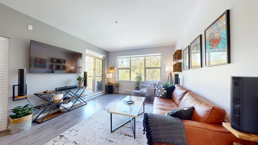 Living room featuring  wood finished floors and direct deck access