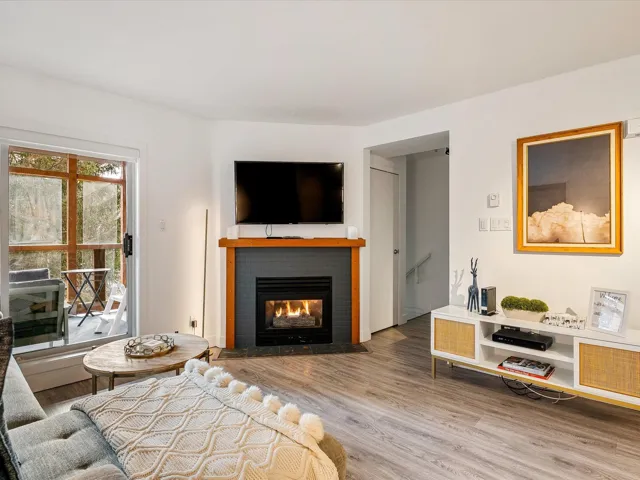 Living room with a fireplace and wood finished floors