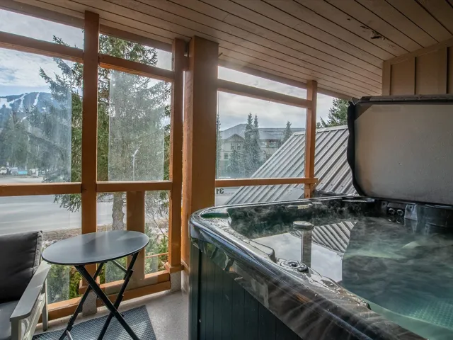 Sunroom with wooden ceiling and a hot tub