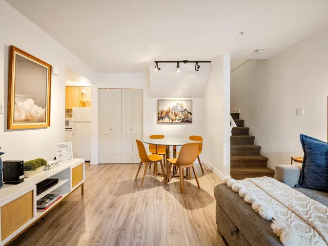 Dining room with stairs, wood finished floors, and baseboards