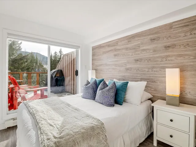 Bedroom featuring access to exterior, a baseboard radiator, and a mountain view