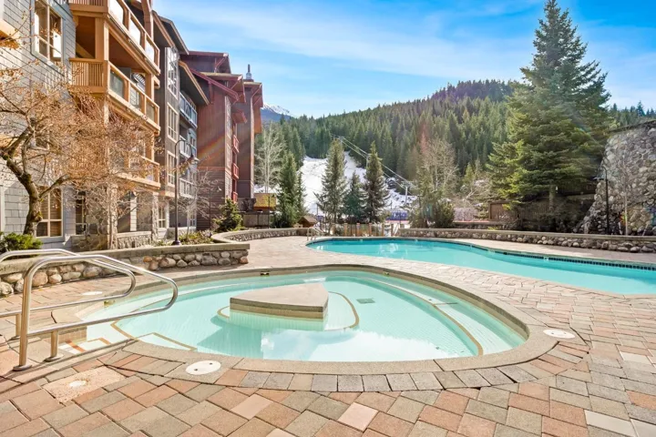 Community pool with a mountain view, a patio, and a jacuzzi