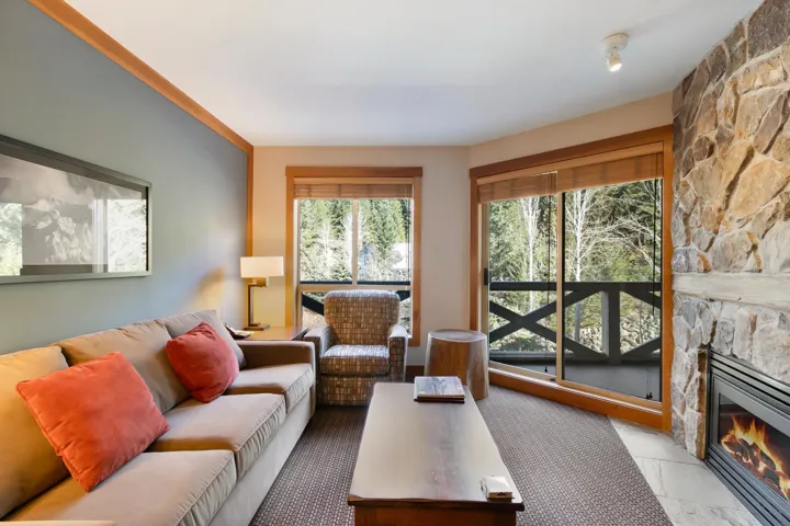 Living area featuring marble finish floor and a fireplace