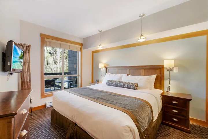 Carpeted bedroom featuring a baseboard heating unit and baseboards