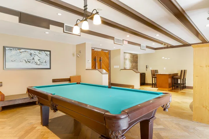 Recreation room featuring a dry bar, baseboards, visible vents, beam ceiling, and recessed lighting