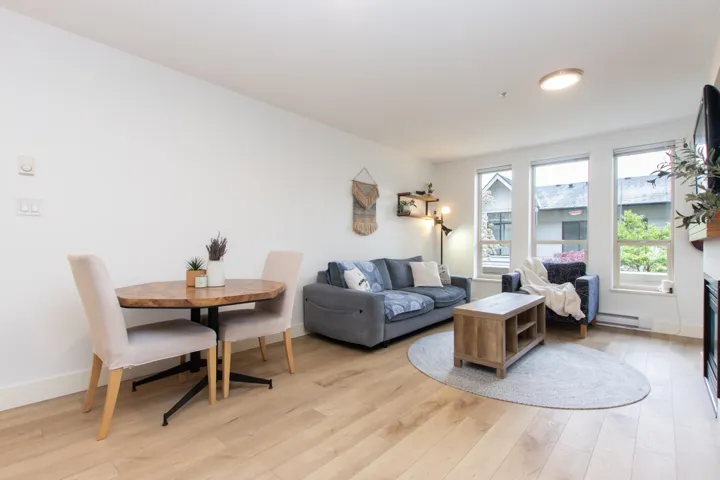 Living area featuring baseboards, baseboard heating, and light wood-type flooring