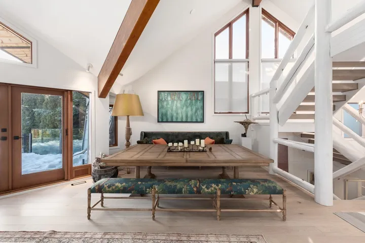 Living area with lofted ceiling, hardwood / wood-style flooring, and healthy amount of natural light