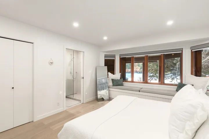 Bedroom featuring light wood-style floors, recessed lighting, a closet, and ensuite bath