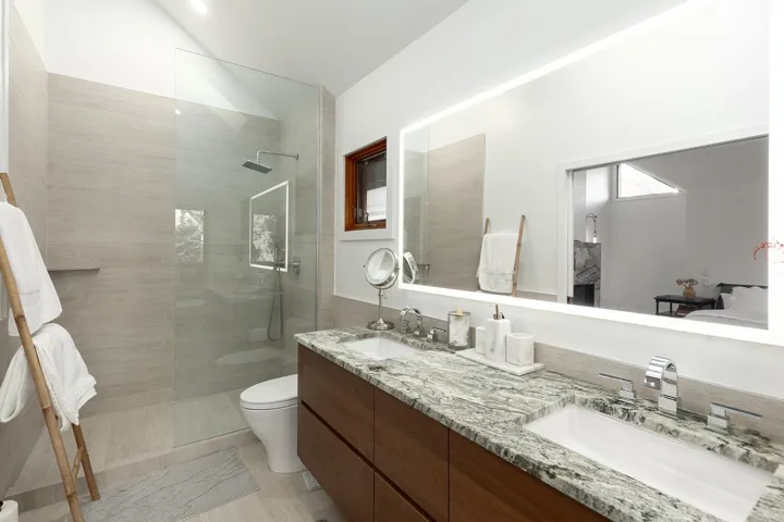 Bathroom featuring a walk in shower and double vanity