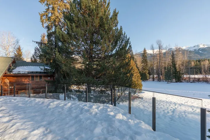Yard covered in snow with a mountain view