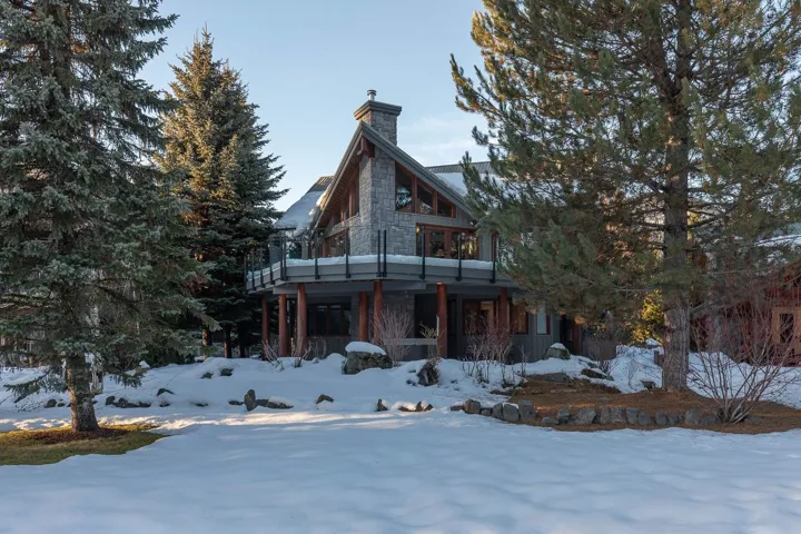 View of front of house with a chimney and a deck