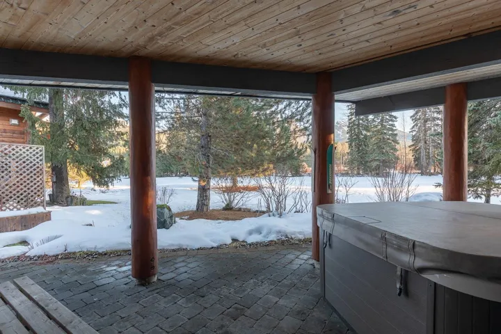 Snow covered patio featuring a hot tub and a patio