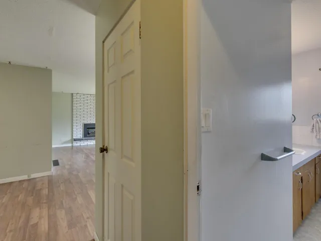 Hall featuring light wood finished floors and baseboards