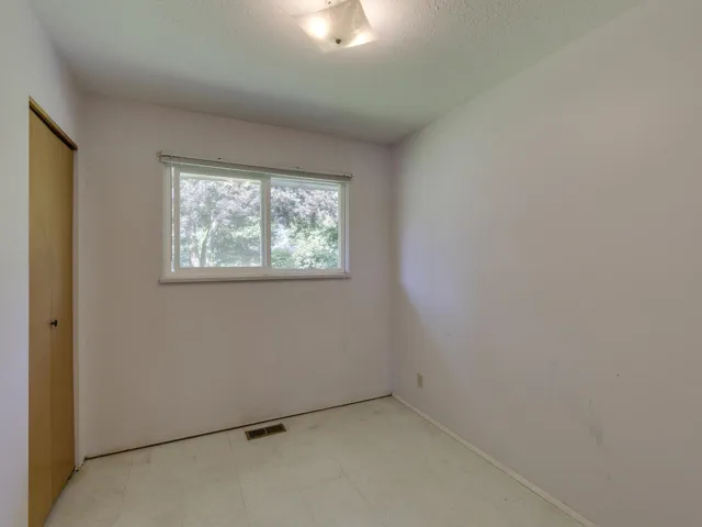Unfurnished bedroom with tile patterned floors and a closet