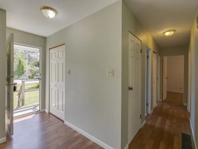 Foyer entrance with dark wood-style flooring