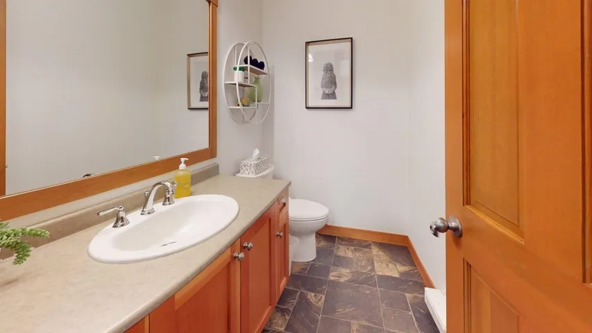 Bathroom featuring vanity and stone finish floors