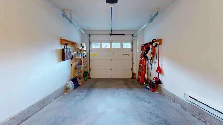 Garage with a baseboard heating unit
