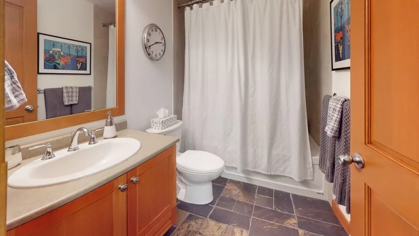 Bathroom with vanity and shower / bath combo