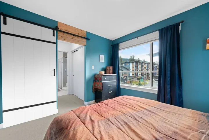 Carpeted bedroom with a barn door