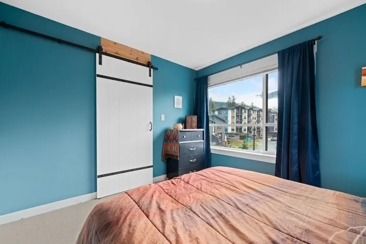 Bedroom featuring carpet flooring and baseboards