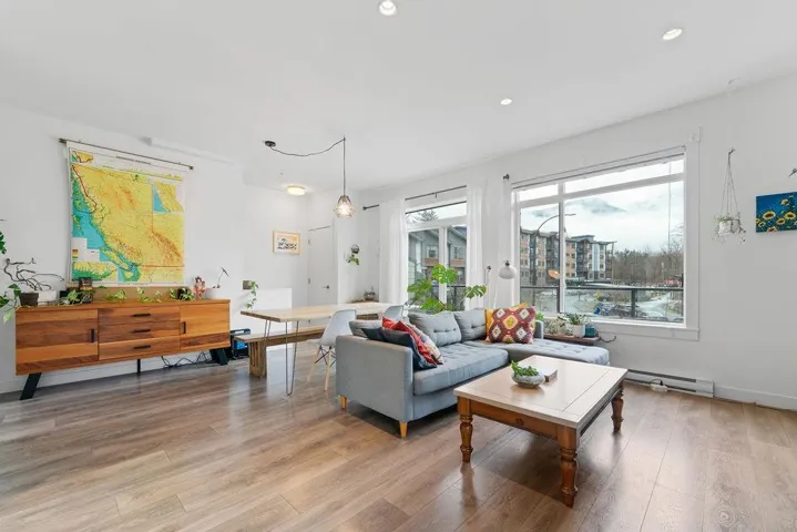 Living area featuring recessed lighting, light wood-style floors, and a baseboard radiator