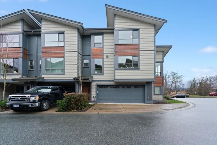 View of front of home with a garage and driveway
