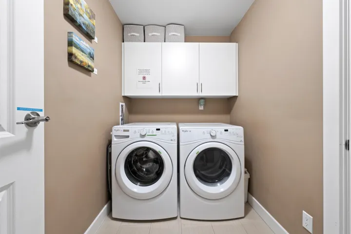 Laundry room with cabinet space, washer and clothes dryer.