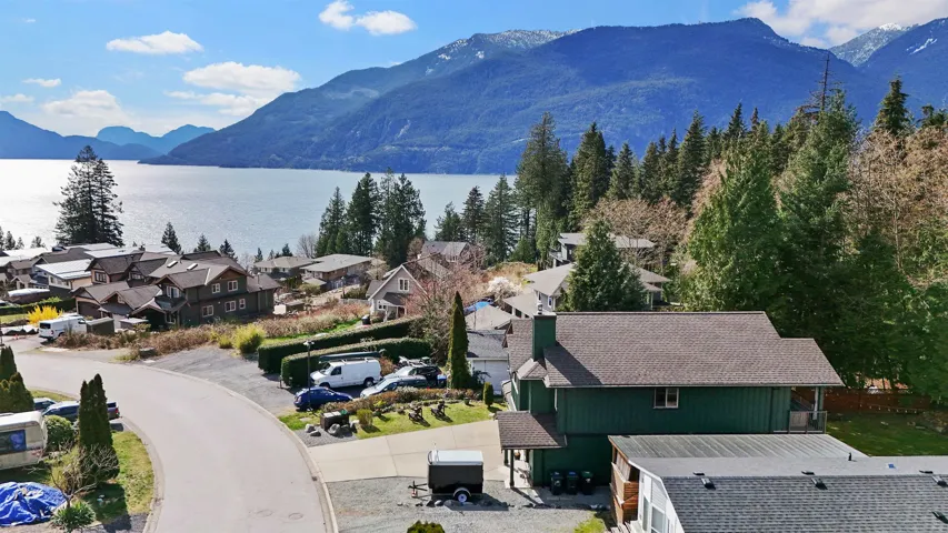 View of mountain backdrop featuring nearby suburban area and a large body of water