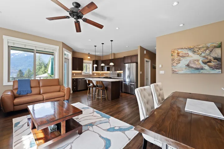 Living area with ceiling fan, wood flooring, and recessed lighting