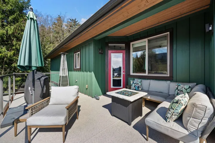 Front corner patio featuring an outdoor living space with a fire pit and area for grilling