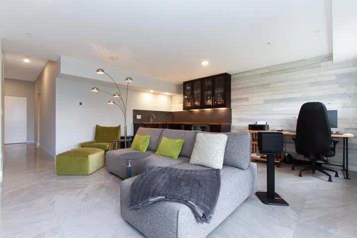 Living area featuring recessed lighting, wet bar, and wood walls