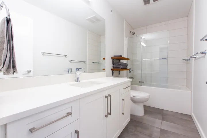 Bathroom featuring visible vents, shower / washtub combination, toilet, tile patterned floors, and vanity