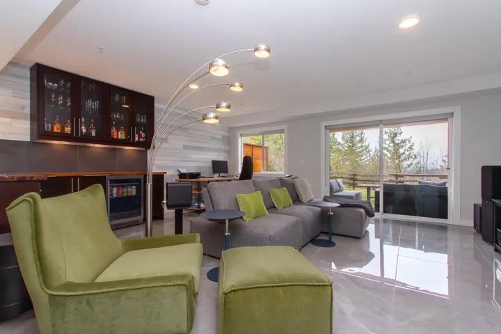 Living area with recessed lighting, wine cooler, a chandelier, and an accent wall