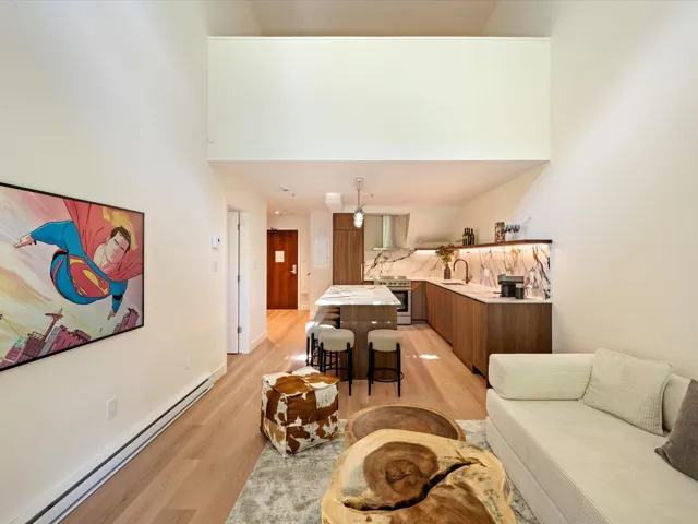 Living area with baseboard heating and light wood-style floors