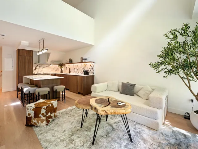 Living area with light wood-style flooring and baseboards
