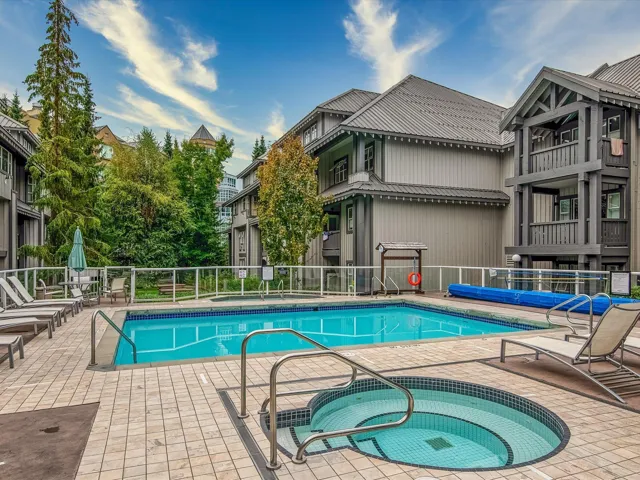 Community pool featuring a community hot tub and a patio