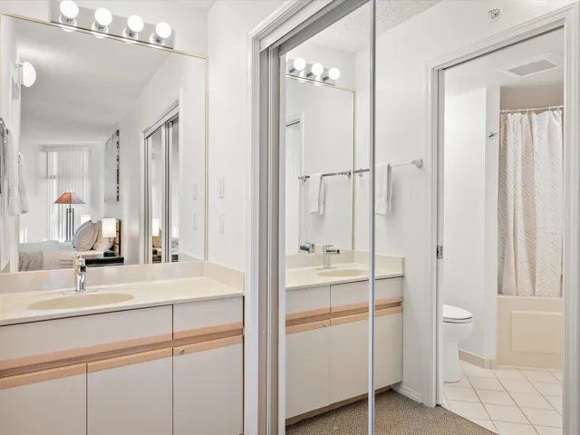 Full bath with light tile patterned floors, vanity, ensuite bathroom, and shower / tub combo with curtain