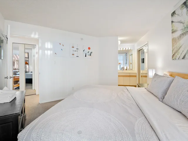 Carpeted bedroom with baseboards and connected bathroom