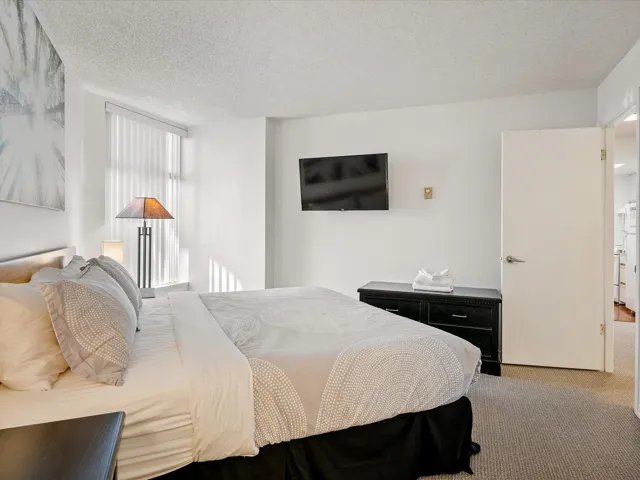 Carpeted bedroom with a textured ceiling