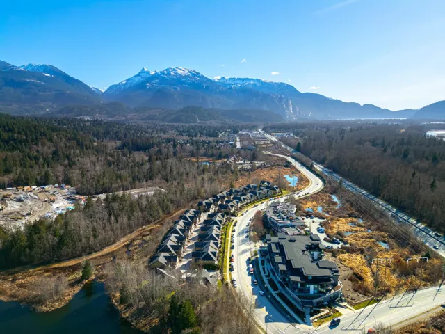 Birds eye view of property with a mountain view and a forest view