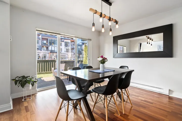 Dining room featuring a baseboard radiator, baseboards, and wood finished floors