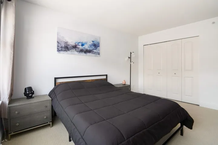 Carpeted bedroom featuring baseboards and a closet