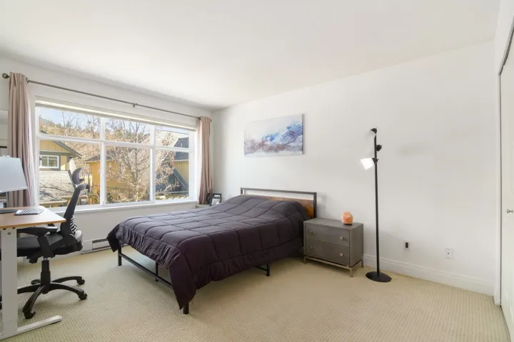 Carpeted bedroom featuring baseboards