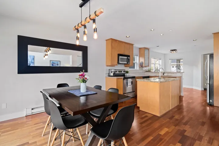 Dining space with recessed lighting, wood finished floors, baseboards, and a baseboard radiator