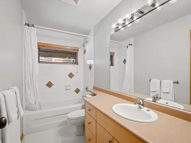 Full bathroom featuring vanity and shower / bathtub combination with curtain
