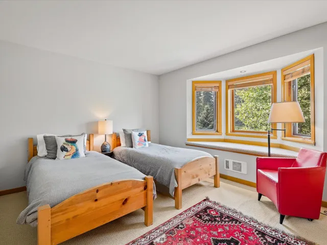 Bedroom featuring carpet flooring and baseboards