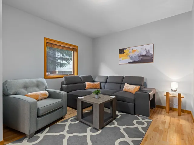 Living area featuring light wood-style floors and baseboards