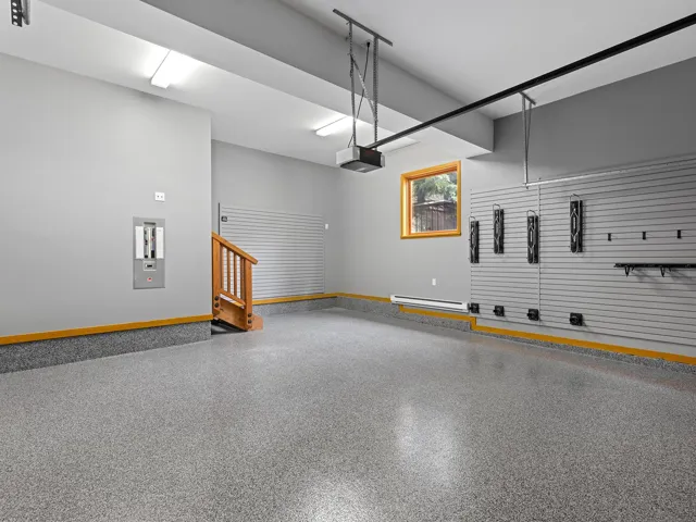 Garage with baseboard heating and a garage door opener